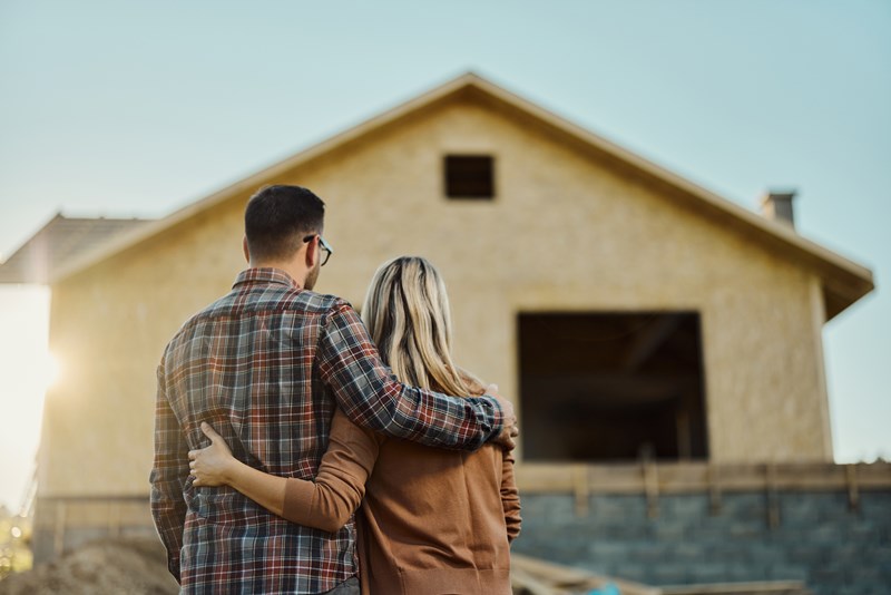 happy couple looking at new home purchase