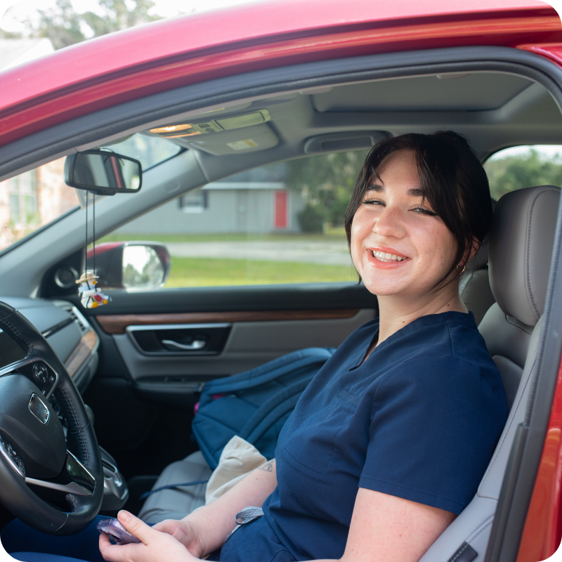 happy nurse in her car
