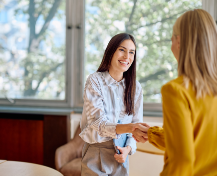 two women shaking hands