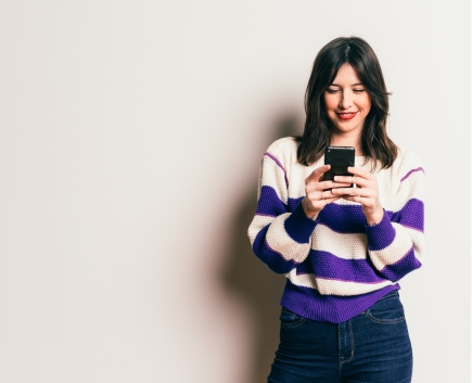 Zelle Coming Soon woman smiling at phone
