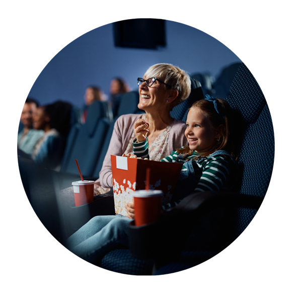elderly woman with young girl at movies