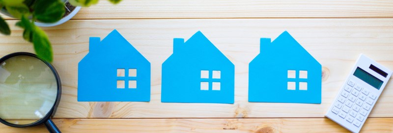 blue houses cut out on wood background