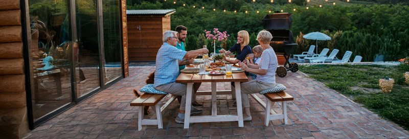 family at picnic table on patio