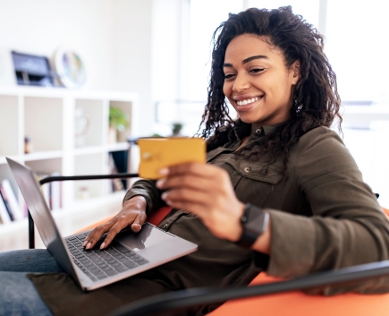 smiling woman with check card