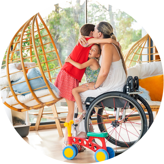 Happy daughters hugging mom in wheelchair