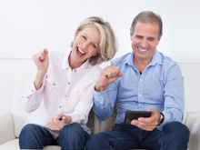 happy couple sitting and cheering